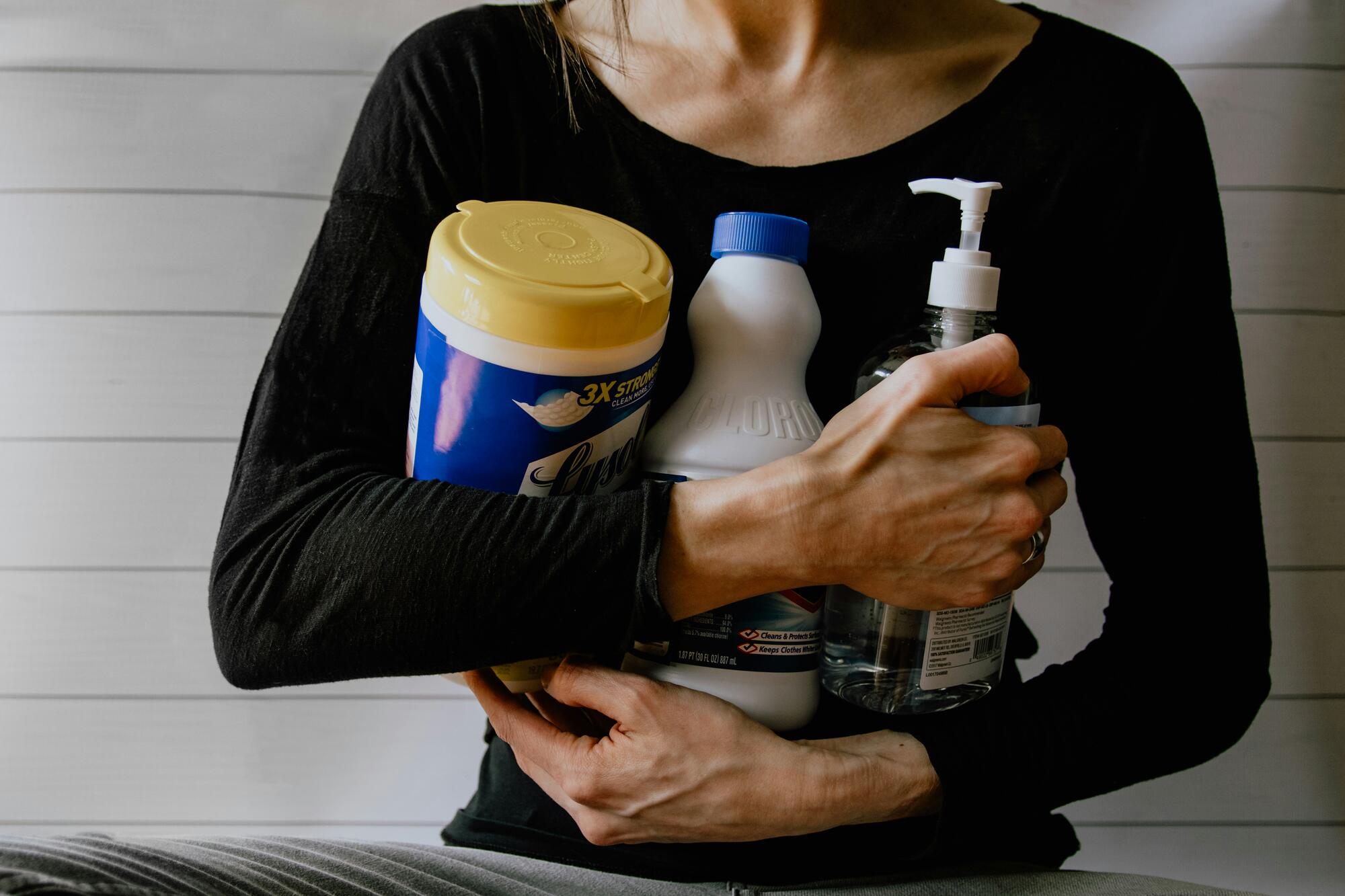 woman holding household cleaners