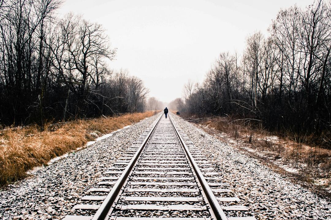 man walking on a train track